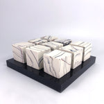 9 cubes on black plinth by Kim Colebrook