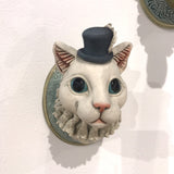 Cat, feather in hat by Helen Higgins