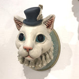 Cat, feather in hat by Helen Higgins