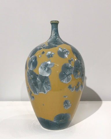 Crystaline bottle form in gold & blue by Simon Rich