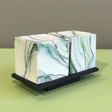 2 medium cubes on burnt black porcelain plinth by Kim Colebrook
