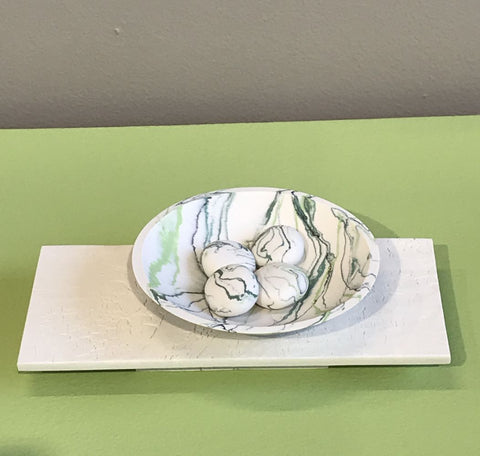 Wide bowl and pebbles on plinth by Kim Colebrook