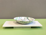 Wide bowl and pebbles on plinth by Kim Colebrook