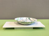 Wide bowl and pebbles on plinth by Kim Colebrook