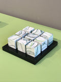 9 small cubes on black plinth by Kim Colebrook