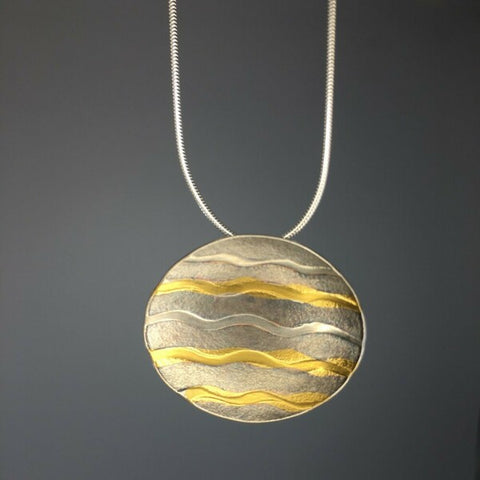 Oval pendant with gold waves by Sandra Elizabeth