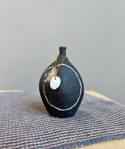 Black stoneware rattling pebble bottle by Kirsti Hannah Brown