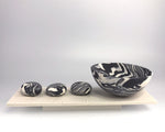 Rocking bowl and 3 pebbles on plinth by Kim Colebrook
