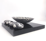 Rocking bowl and 4 pebbles on plinth by Kim Colebrook