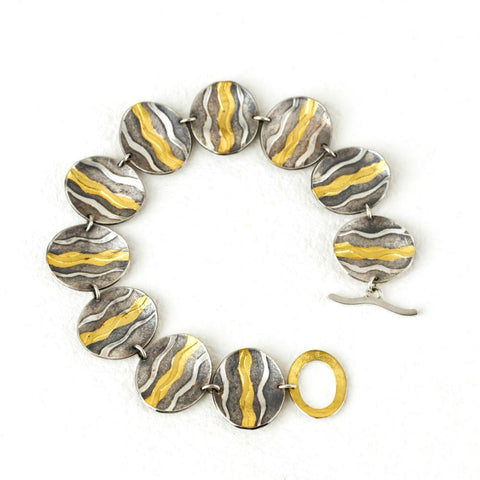 Wave bracelet oxidised with gold waves by Sandra Elizabeth