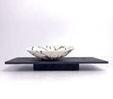 Wide rocking bowl and 3 pebbles on porcelain plinth by Kim Colebrook