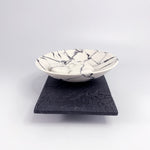 Wide rocking bowl and 3 pebbles on porcelain plinth by Kim Colebrook