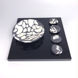 Wide rocking bowl and 4 pebbles on plinth by Kim Colebrook