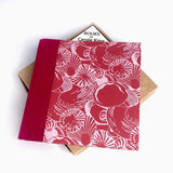 Shells on red sketchbook by Carole King