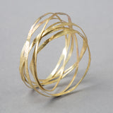 'Amrwd' Wrapped Bangle in Brass by Ann Catrin Evans
