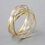 'Amrwd' Wrapped Bangle in Brass by Ann Catrin Evans